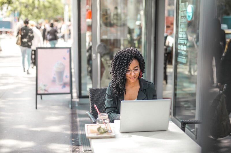 Sales representative working with a laptop in a customer-facing retail location